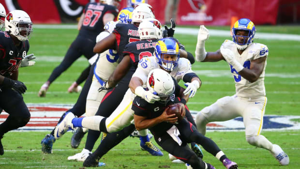 Los Angeles Rams defensive end Aaron Donald (99) sacks Arizona Cardinals quarterback Kyler Murray (1) in the first half during a game at State Farm Stadium.